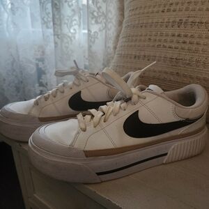 Nike White Sneakers with Black Swoosh and Tan Accent